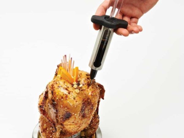 Broil King Marinade Injector injecting into a chicken