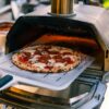 Hot pizza coming out of an Ooni Karu 16